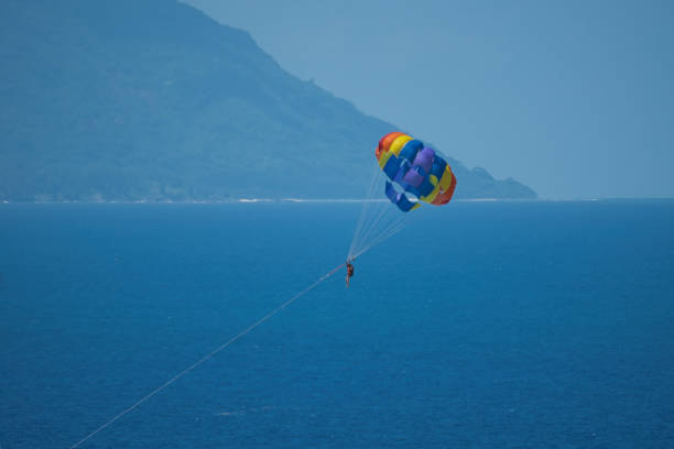istock Single person parachuting at beau vallon beach 1987293719