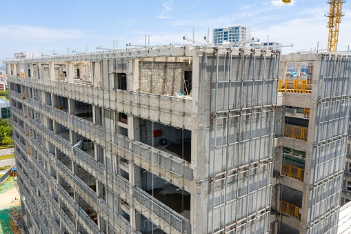 A high-rise university teaching building under construction, with some engineering facilities in operation. Wuhan, China.