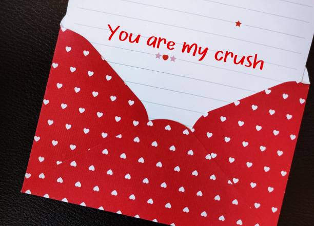 istock Red heart envelope with with handwritten text on a note paper YOU ARE MY CRUSH, concept of love confession on Valentines day, to tell someone romantic feeling unbeknownst to that person 1987303353