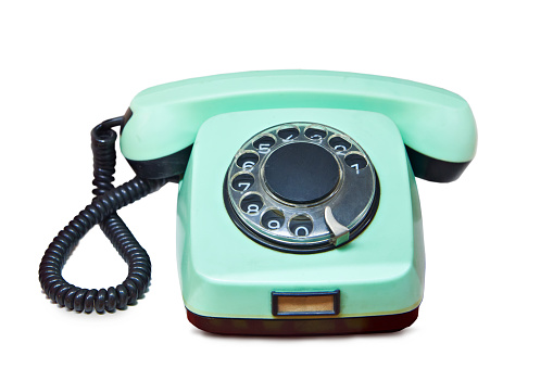 Old vintage green home landline telephone isolated white background