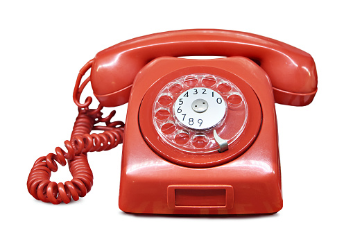 Old vintage red home landline telephone isolated white background
