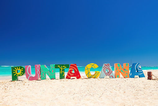 Punta Cana Bavaro beach resort and color letters on the sea sand, summer tropical caribbean vacation.