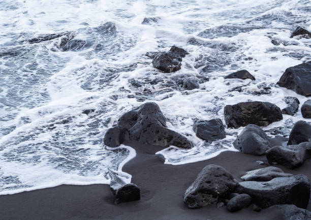 istock beach with black volcanic sand on  Tenerife 1987325075