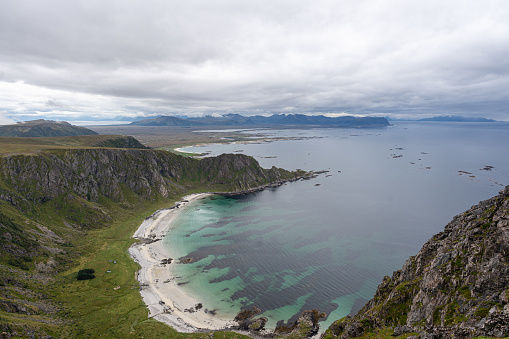A picturesque coastal vista, showcasing a breathtaking beach and ocean, as seen from a mountainside