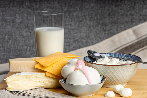 Celebrating the Jewish holiday Shavuot. Kosher fresh dairy products, milk and cheese, wooden background. Dairy products on a wooden background. Shavuot concept.