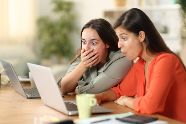 istock Shocked tele workers checking laptop at home 1987349880