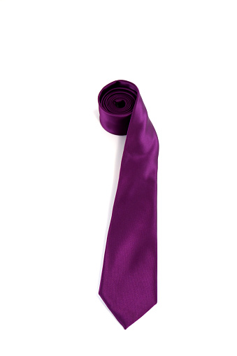 A violet color polyester fabric necktie rolled on white background close-up view single object concept