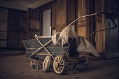 old antique baby carriage in an abandoned palace