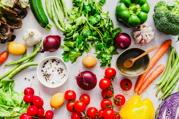 istock Fresh vegetables, salt and olive oil on a table 1987358578