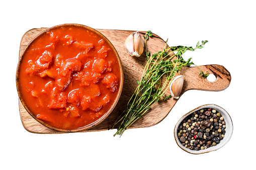 Canned chopped tomatoes, tomato sauce in a bowl.  Isolated on white background. Top view