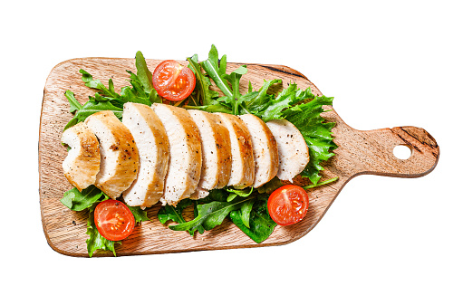 Fresh salad with grilled chicken breast, arugula and tomato. Isolated on white background. Top view