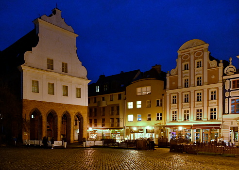 Szczecin, West Pomerania, Poland: Old Town Hall (originally from the 15th century) and façades in the cobbled Old Market Square at night (Northeast corner) - these buildings were very damaged during World War II, the current structures were rebuilt afterwards - Stare Miasto.