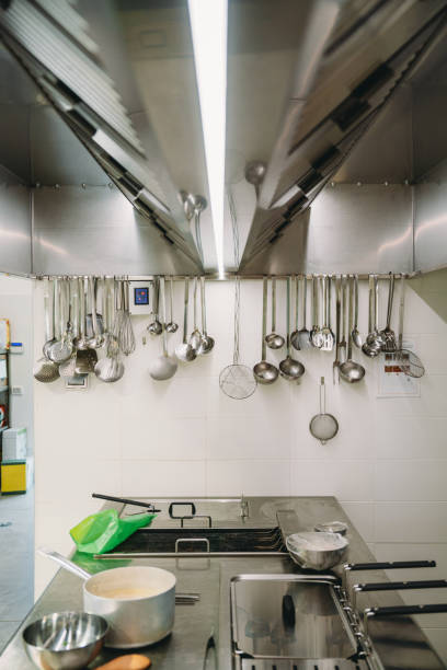 istock Ladles hanging in a professional restaurant kitchen 1987421385