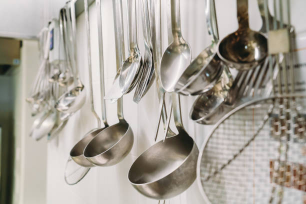 istock Hanging ladles in a professional restaurant's kitchen 1987421393