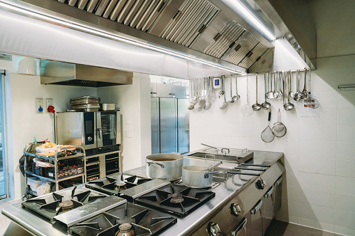 Interior shot of a professional restaurant's kitchen. New stainless steel commercial kitchen.