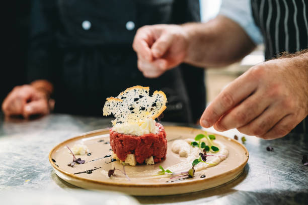 istock Chefs are preparing a plate in the kitchen of the restaurant 1987421415