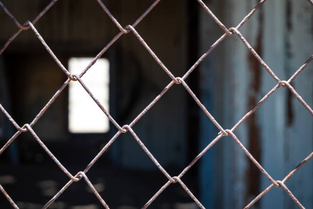A closeup of a rusty mesh wire fence