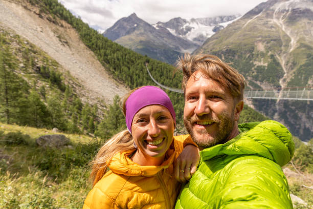 istock Couple hiking selfie suspension bridge 1987434560