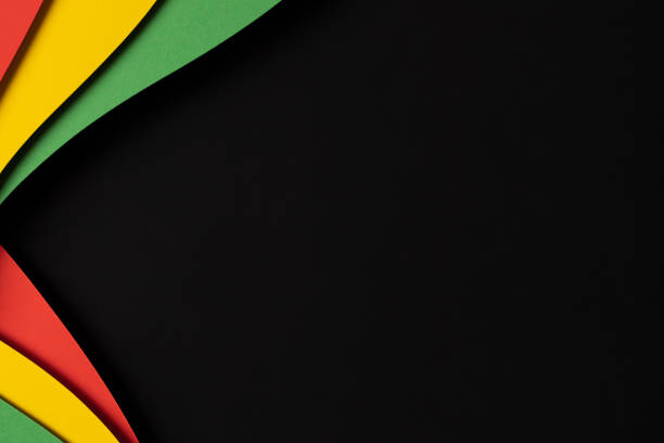 istock Black History Month color banner background. Abstract paper cut style composition with layers of geometric shapes and wavy lines in red, yellow, green colors 1987436180