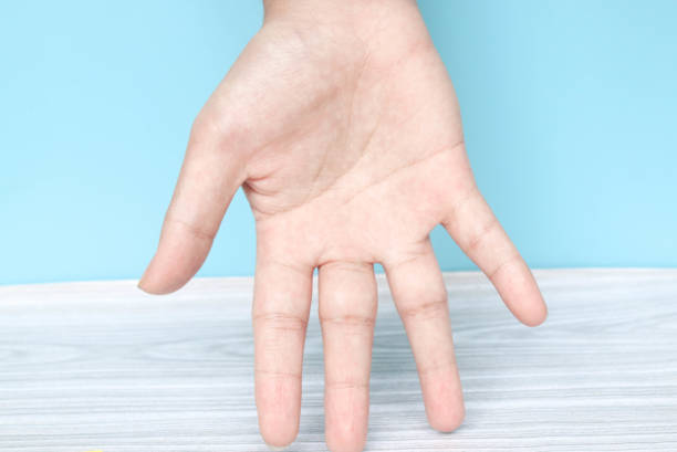 Empty hand palm isolated on blue background. Body parts concept. One hand is turned upside down