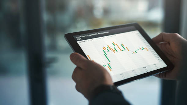 istock Hands, tablet and data with business person closeup in office for analysis, information or statistics. Finance, chart or graph with accounting infographic on screen or technology display in workplace 1987444660