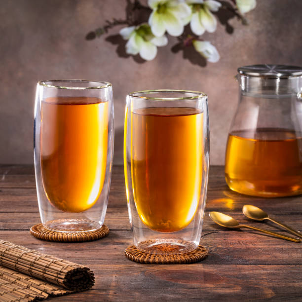 istock Black tea in a glass teapot and cups. On a dark background. Tea concept. 1987446828
