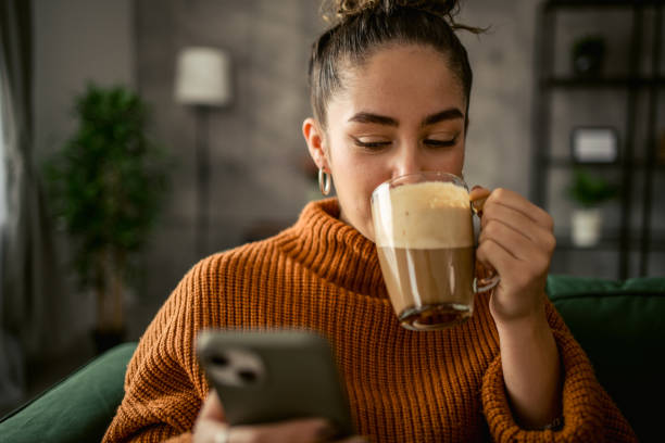 istock Young woman drinking coffee in the morning 1987457274
