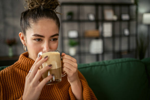 istock Young woman drinking coffee in the morning 1987457816