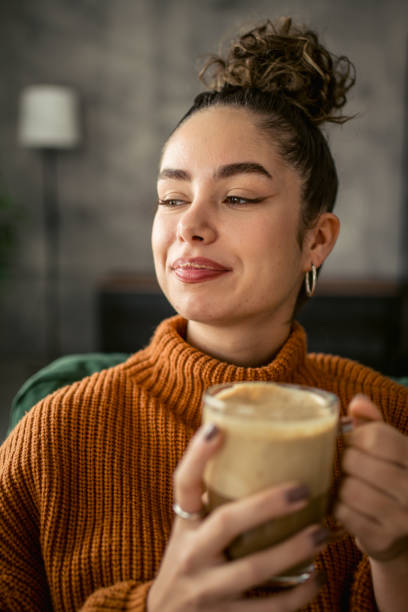 istock Young woman drinking coffee in the morning 1987457818
