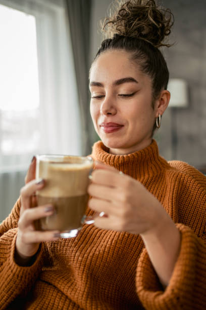 istock Young woman drinking coffee in the morning 1987457829