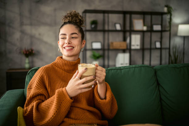 istock Young woman drinking coffee in the morning 1987458333