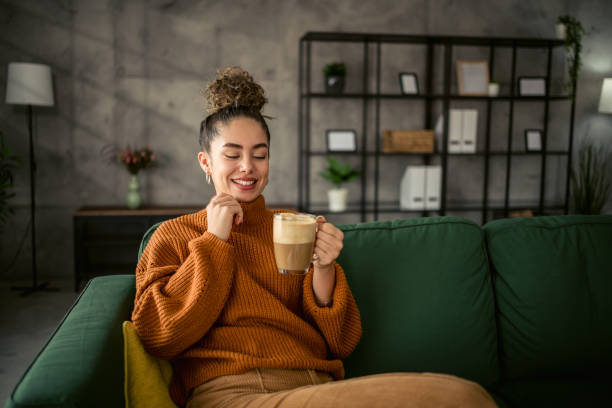istock Young woman drinking coffee in the morning 1987458351