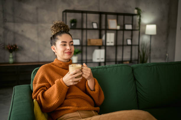 istock Young woman drinking coffee in the morning 1987458352