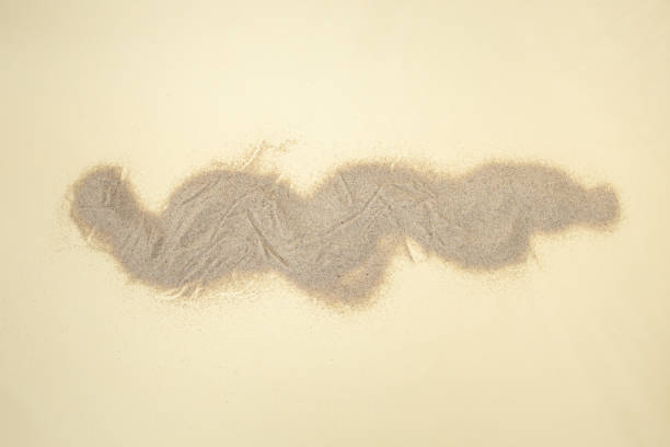 Desert sand pile, dune backdrop on cream background abstract soft focus close up