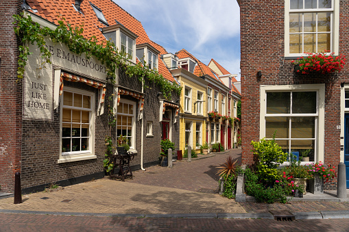 Delft, Netherlands - July 11, 2023: Typical buildings in the old town of the beautiful city of Delft, Netherlands, in a sunny day.
