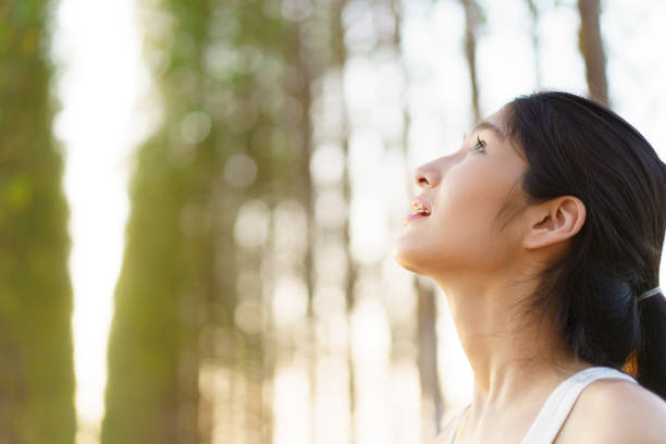 istock Cute Asian young woman relaxing in nature. 1987489626