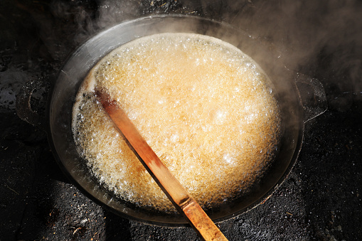 White granulated sugar boiled in a big pot