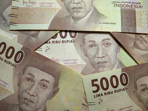 Indonesia money, new series rupiah of banknote. Rupiah money for buying and selling transactions in Indonesia. Indonesian currency. Paper money. Several five thousand rupiah notes.