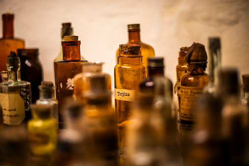 old medicine bottles behind the ancient display case bottles with ancient brown writings in Cuzco Inca city on the Peruvian highlands