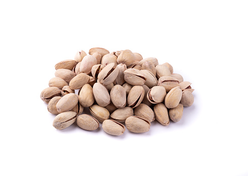 Salted roasted pistachios isolated over white background.