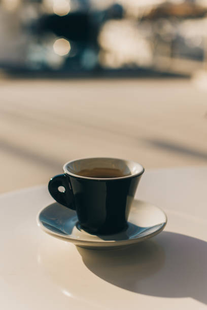 istock Cup of black coffee on a table in a street cafe. 1987571003