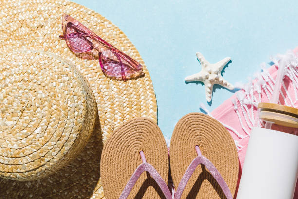 istock Summer flat lay with straw hat, sunglasses and beach accessories on blue background with trendy sunlight, sun and shadow. Vacation, holiday, summer creative concept, copy space, banner. 1987581268