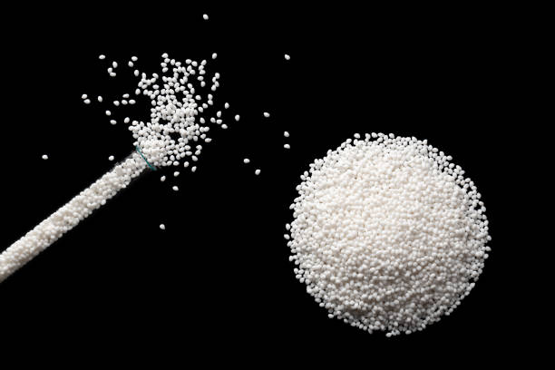 istock Top view of a laboratory glass flask with samples of white polymer plastic granules. 1987589382