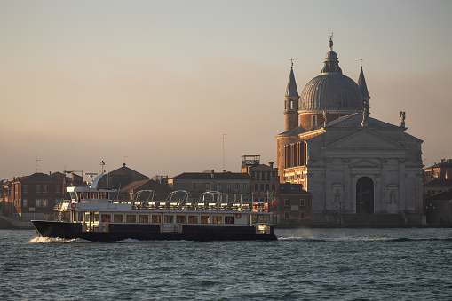 Touristic Discovery Boat Passing in Empty in front of the Holly Redeemer Church in Venice at Sunrise