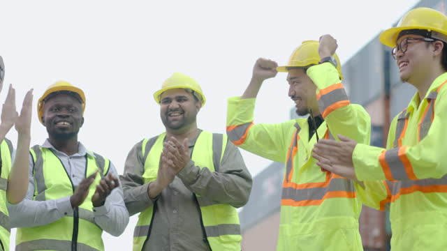Group of professional dock worker and engineering people stand with their hands together in container terminal, Business Cargo and Logistic, Success teamwork, Motivational, slow motion