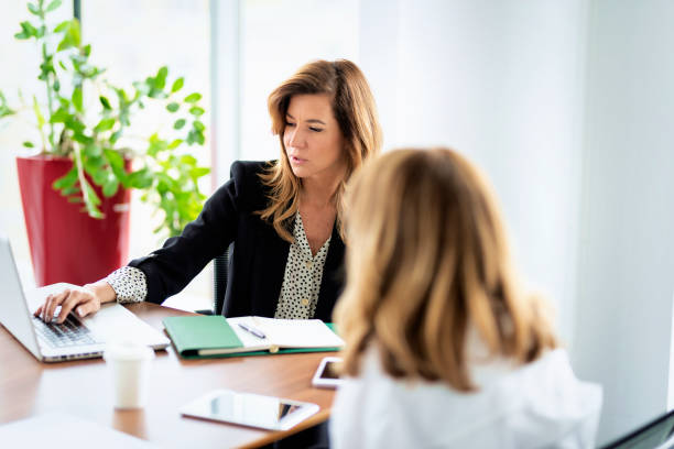 istock Group of business people sitting at desk and talking about new project 1987609162