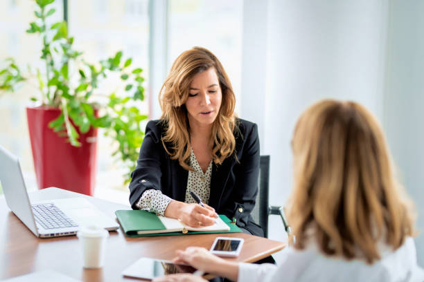 Group of business people sitting at desk and talking about new project stock photo