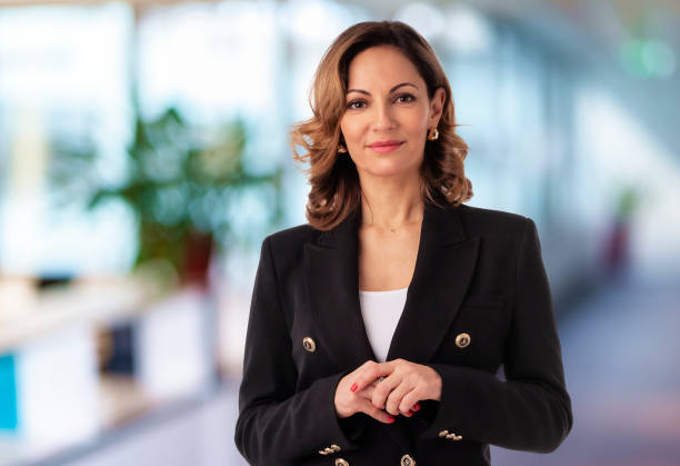 istock Executive blond haired businesswoman wearing black jacket and standing at the office 1987609201