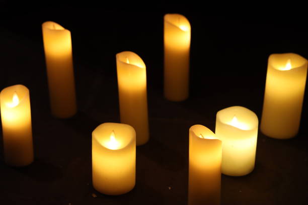 istock Group of large glowing yellow candles 1987610310
