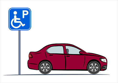 A disabled person's car is parked near a traffic sign - parking for disabled people.  